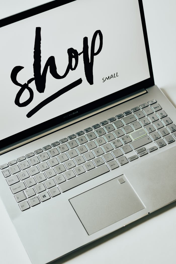 A focused image of a laptop displaying 'shop small' on the screen, promoting small businesses.